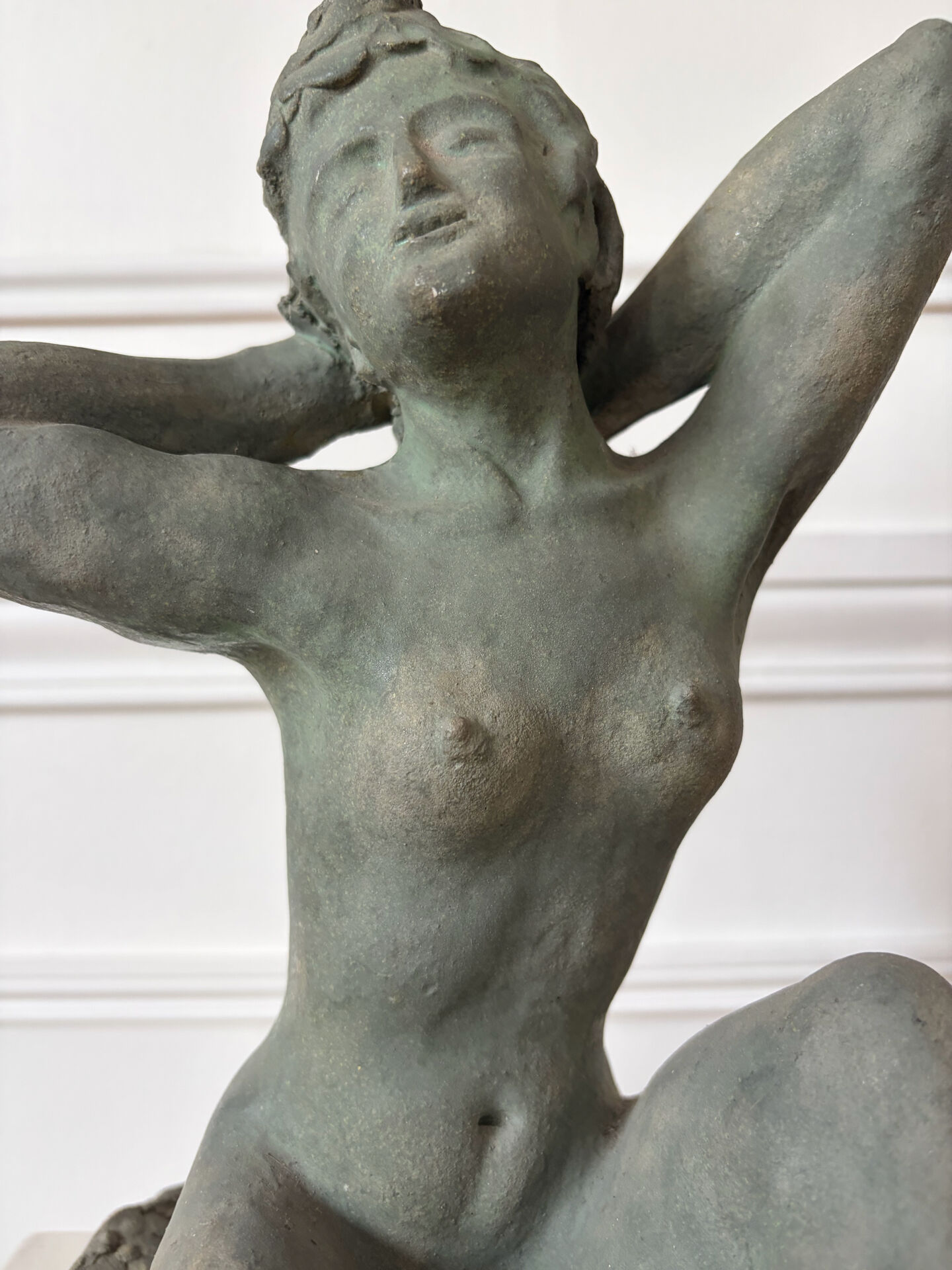 Sculpture of a naked woman titled "Youth" in terracotta.