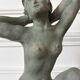 Sculpture of a naked woman titled "Youth" in terracotta.