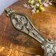 Hand candlestick, peacock shape, in bronze
