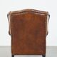 Sheepskin leather wingback chair with a red corduroy seat cushion
