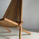 Foldable designer armchair in wooden slats