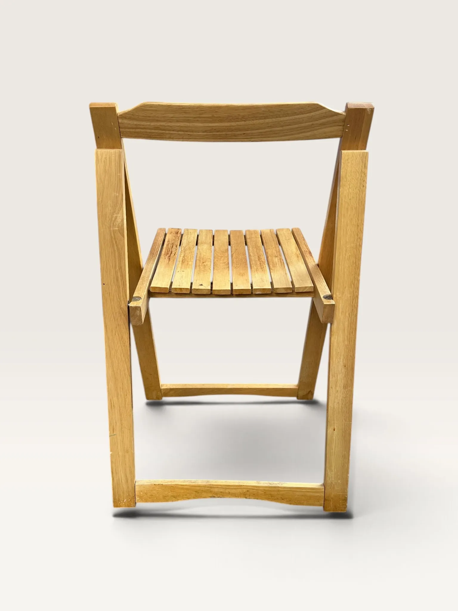 Blonde wooden folding chair in the style of Aldo Jacober.