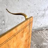 Vintage coffee table with gold-gilded legs and light brown wood veneer geometric inlaid top