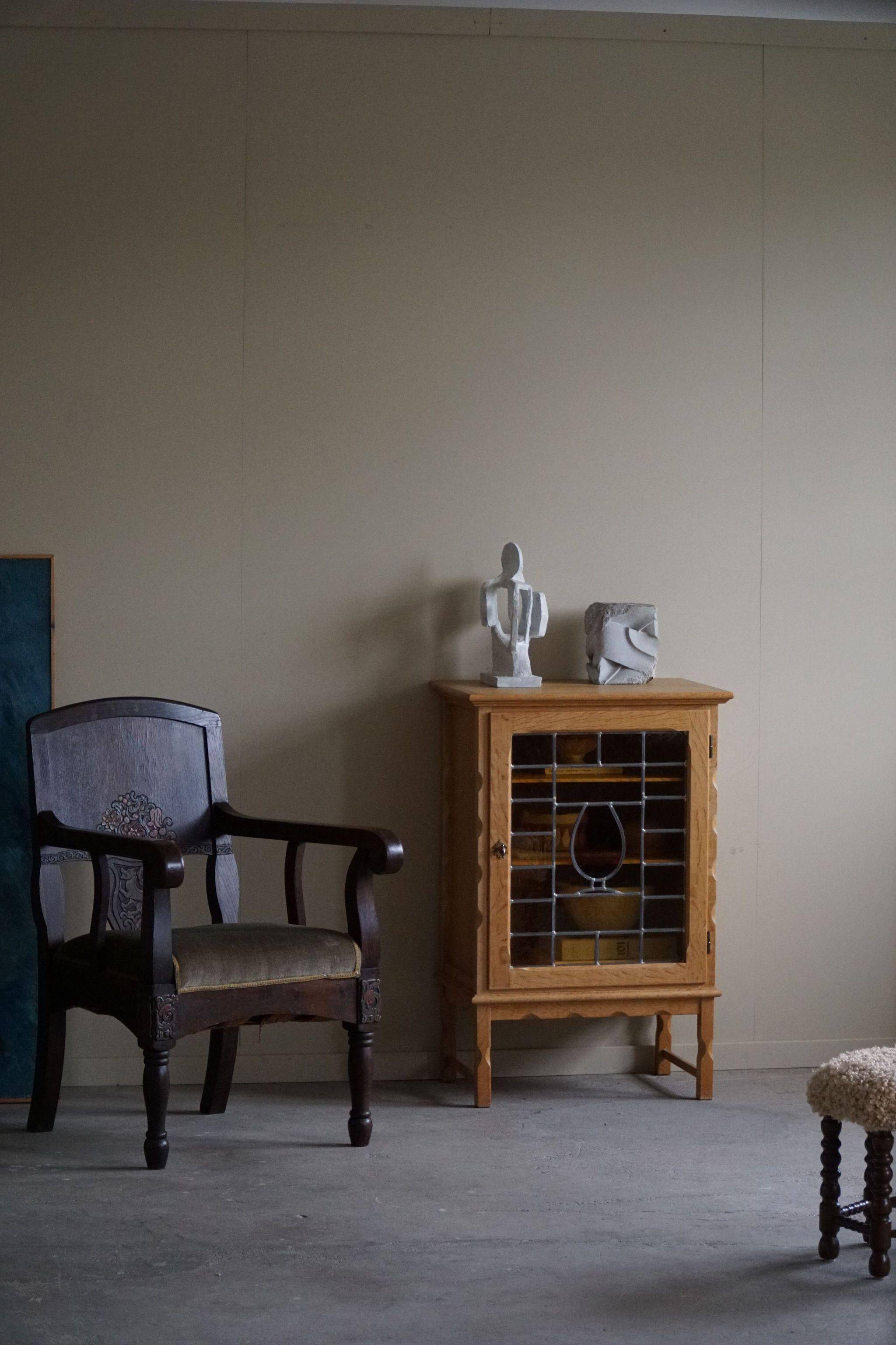 Scandinavian wardrobe in natural oak with a glass front.