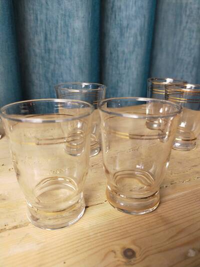 Set of 9 antique glasses with gold rim.