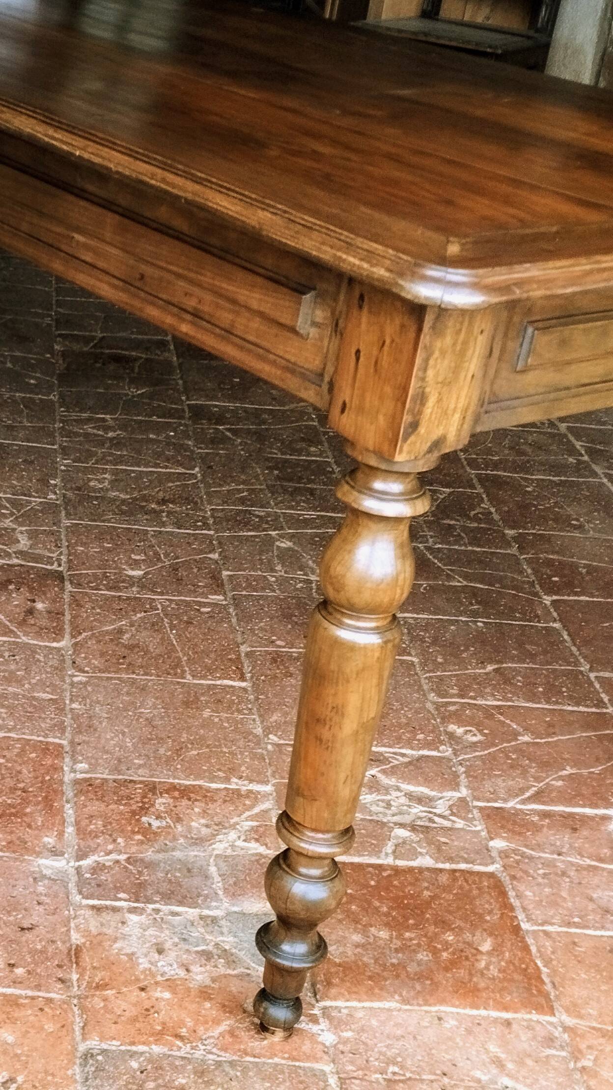 Old French farmhouse table in walnut with turned legs.
