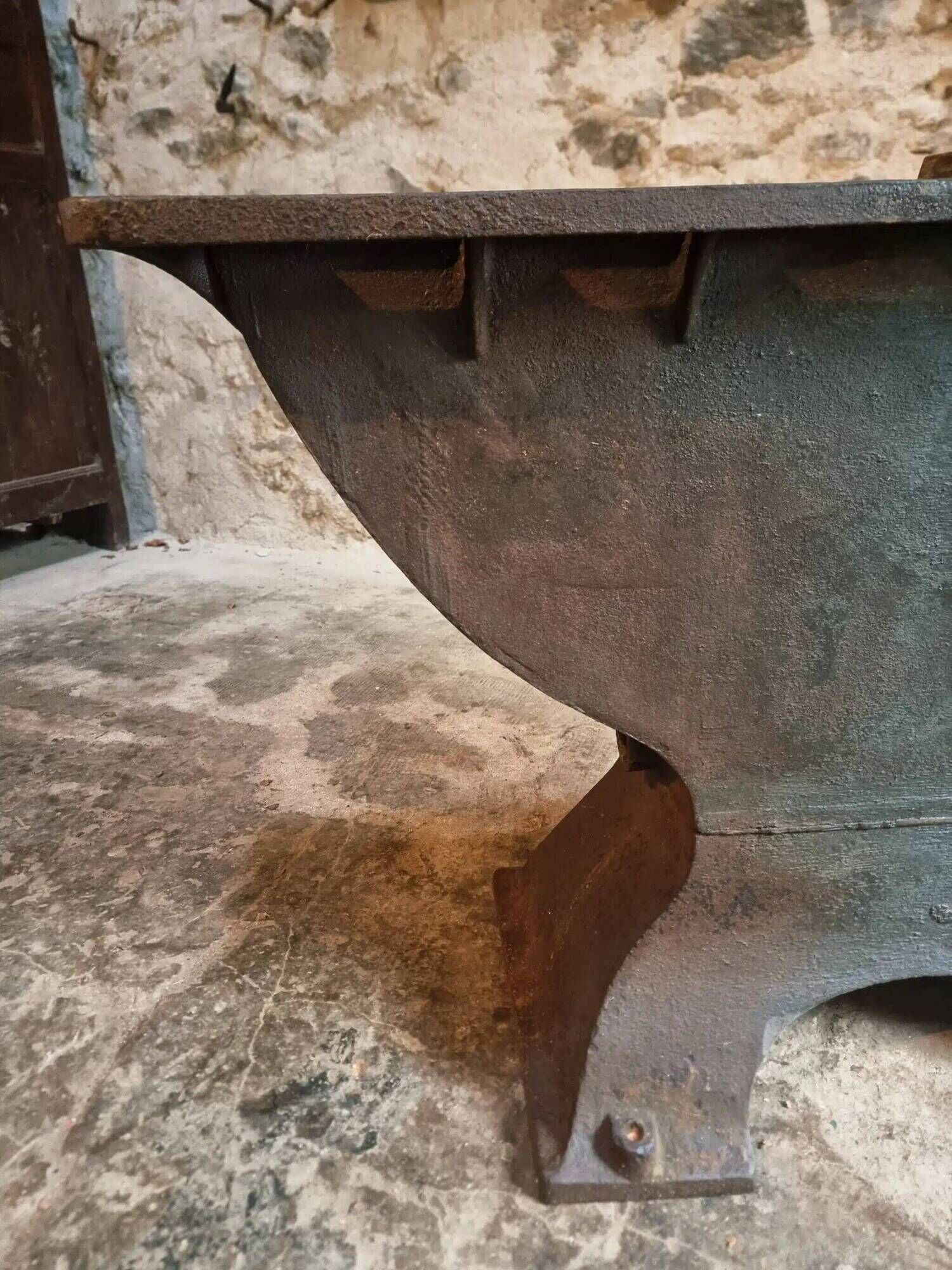 Old French industrial table with a cast iron base and a pine top.