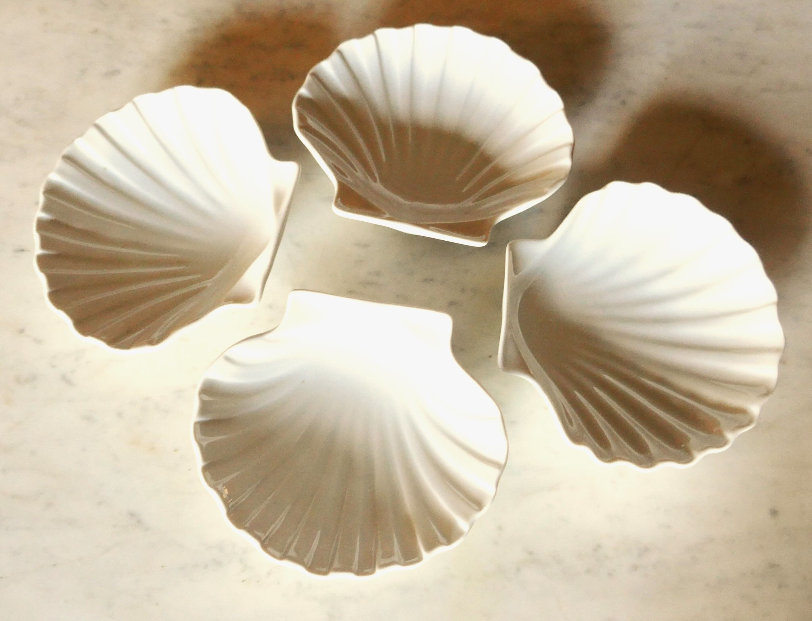 4 antique cups in the shape of a white porcelain shell