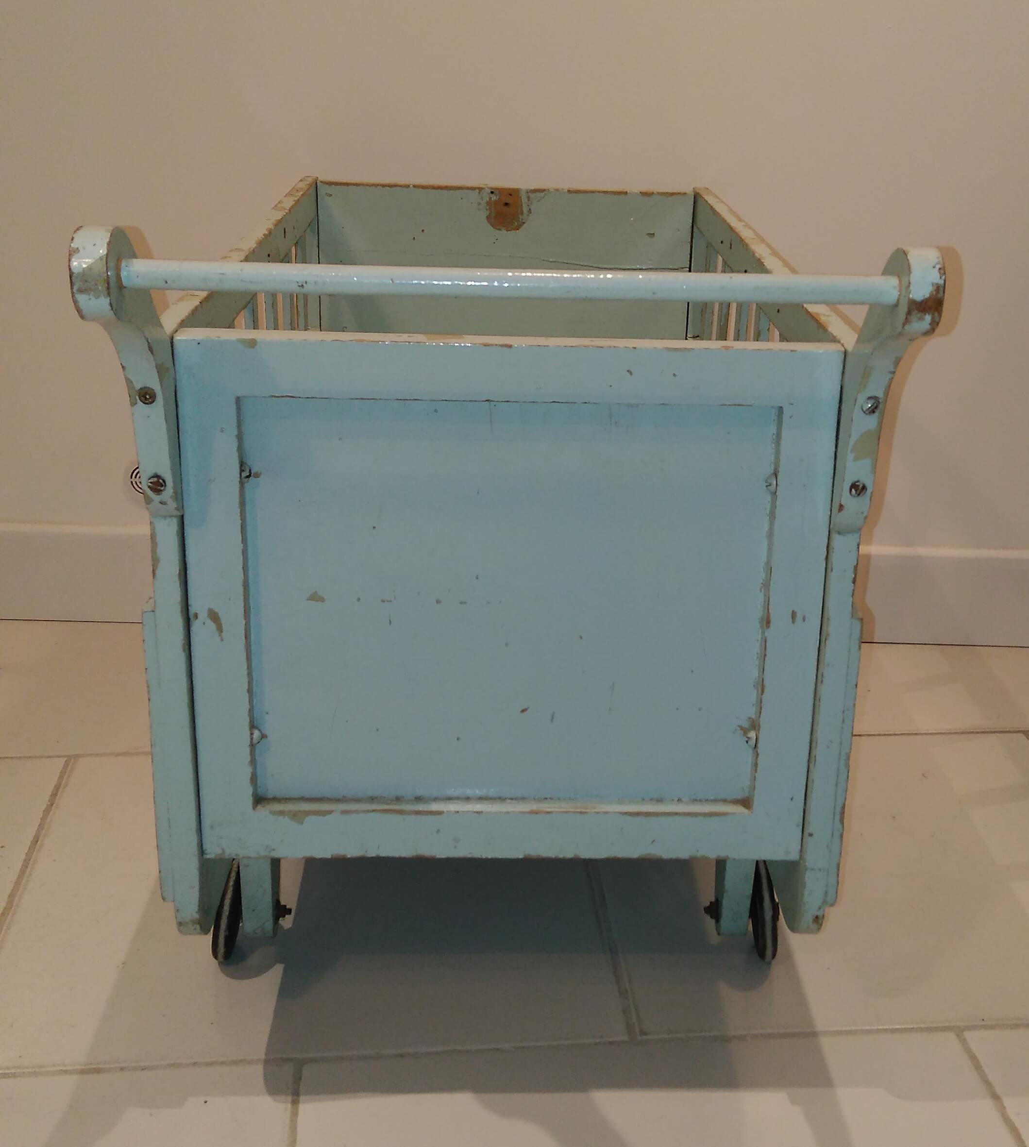 Cradle vintage wooden trailer on wheels