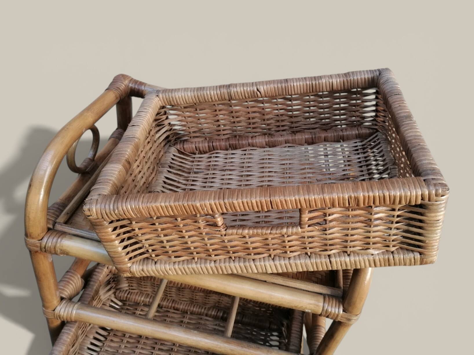 Small storage unit / freestanding shelf in light rattan.