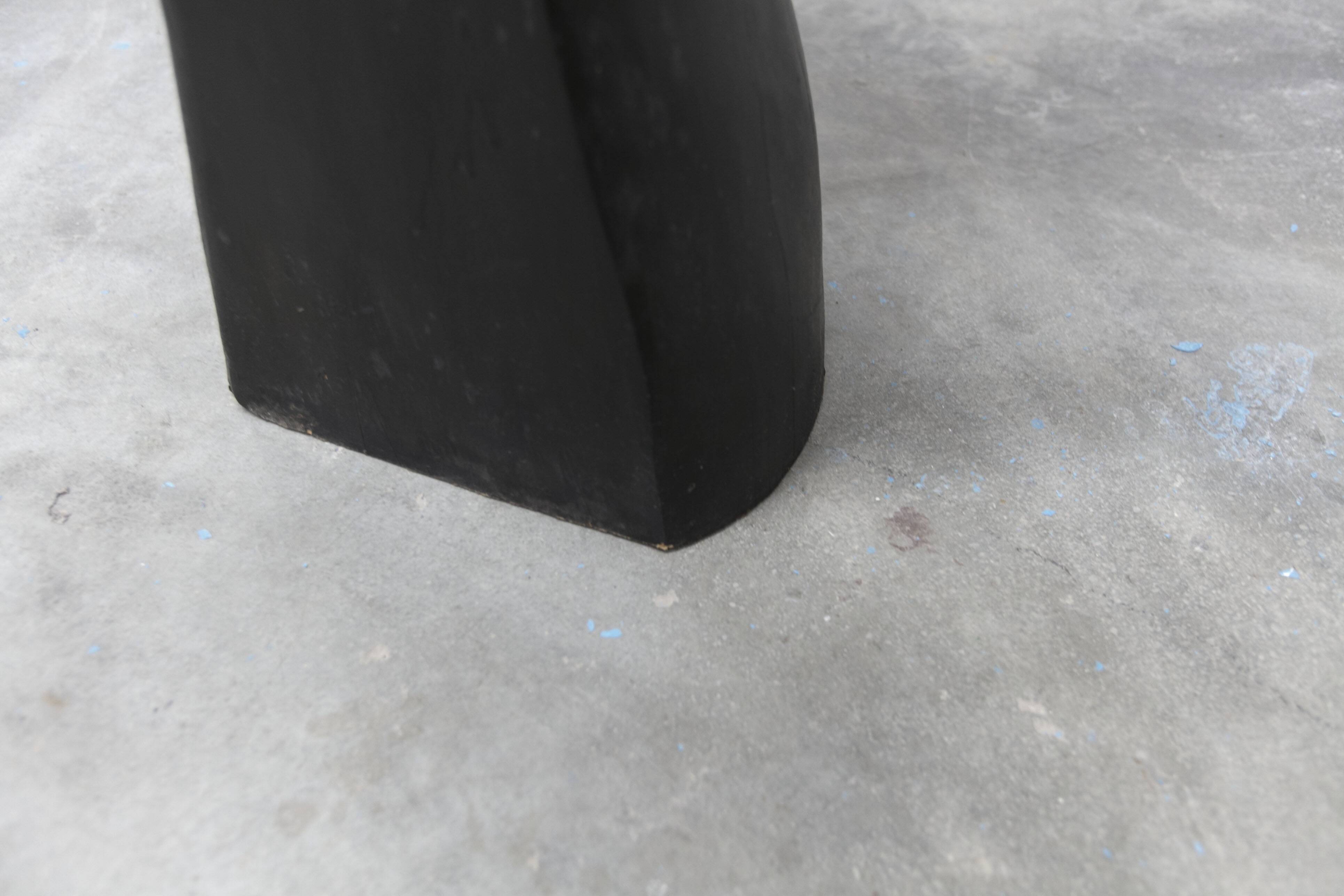 Black armchair chair in carved wood in the shape of a hand