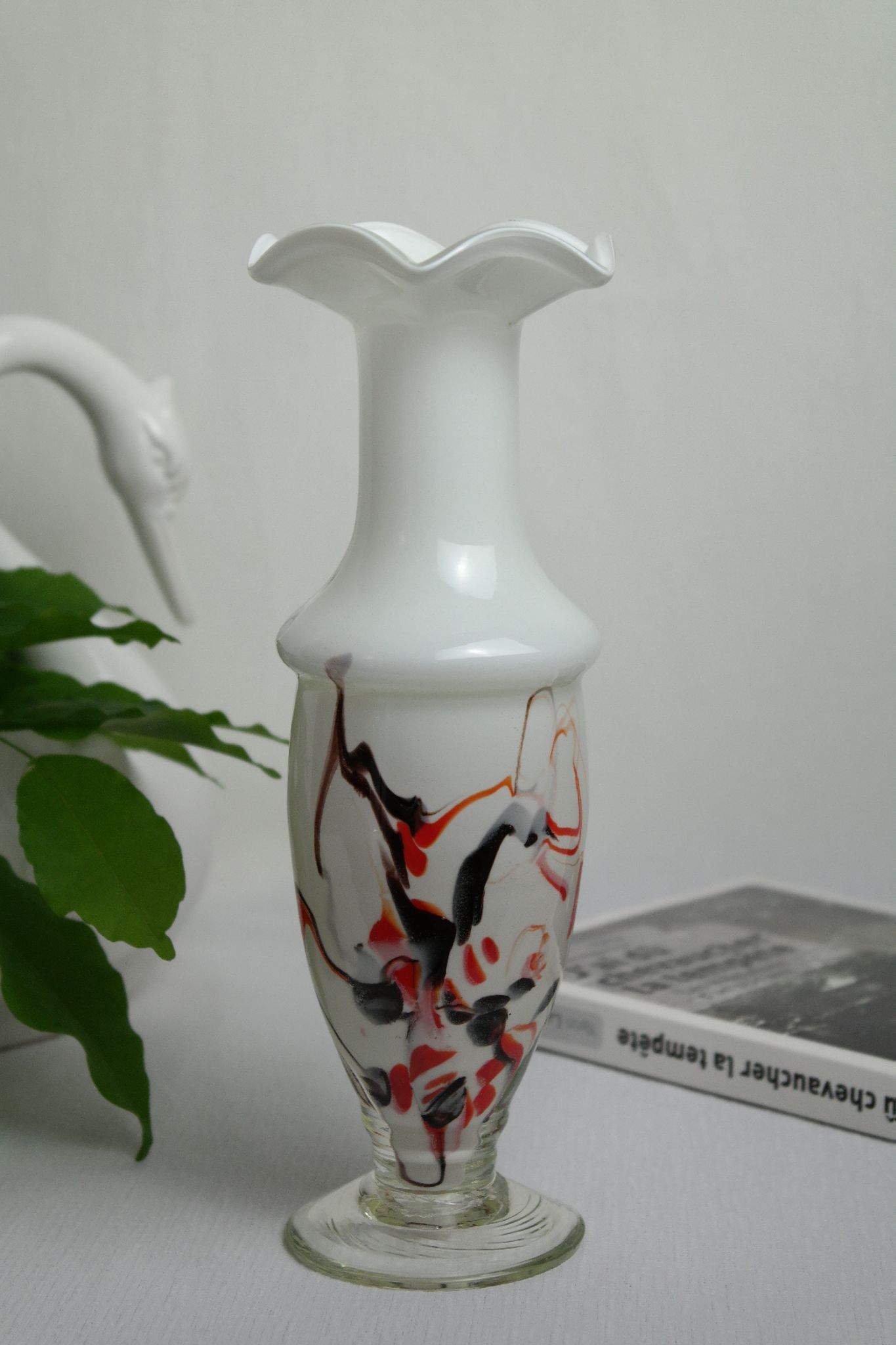 Corolla vase in white opaline with orange-brown patterns.
