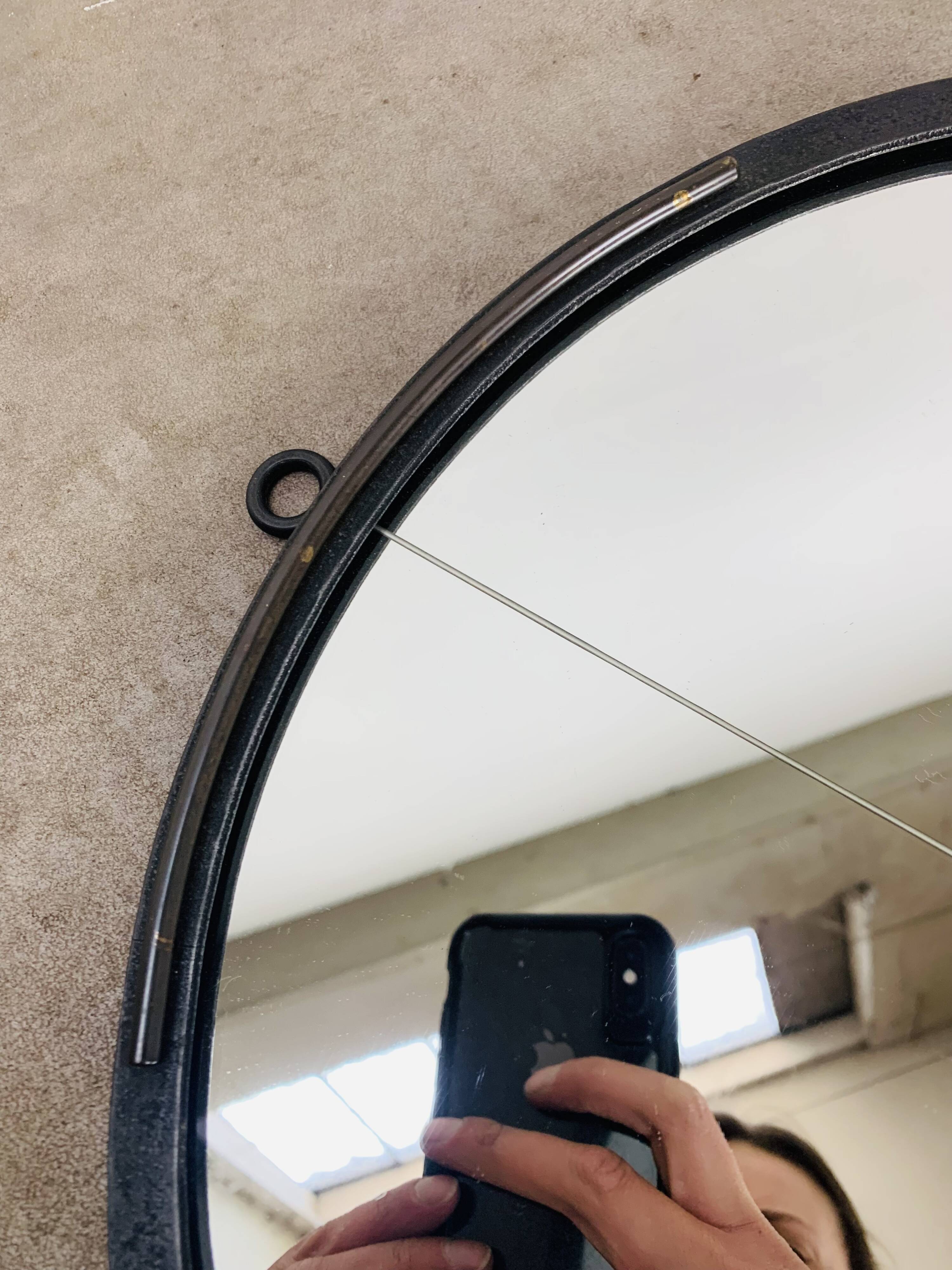 Oval mirror from the 1950s, wrought iron and brass.