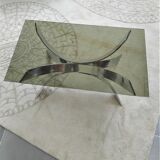 A chrome-shaped table and a 70s glass tray
