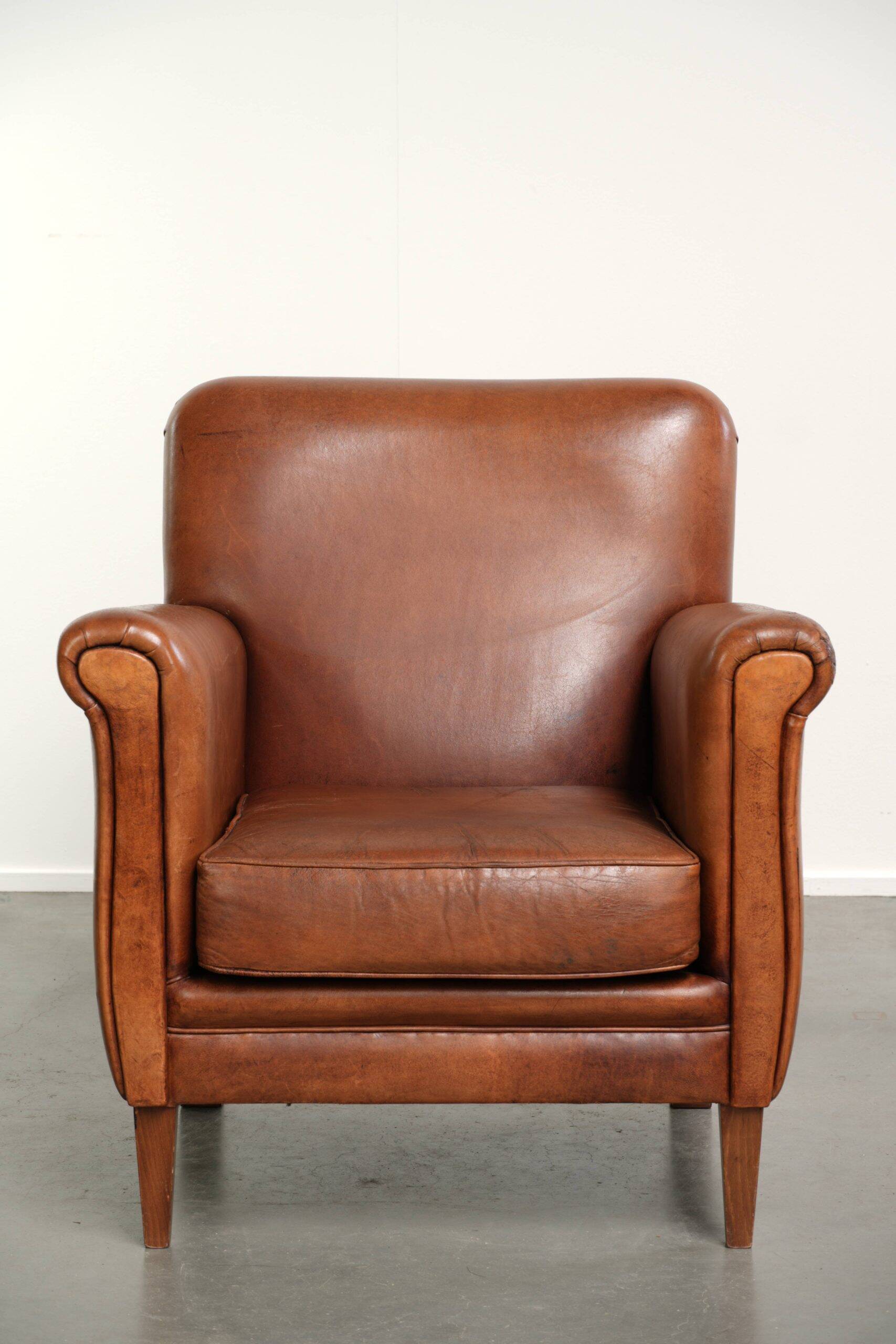 Sturdy vintage sheepskin armchair with a beautiful cognac colour