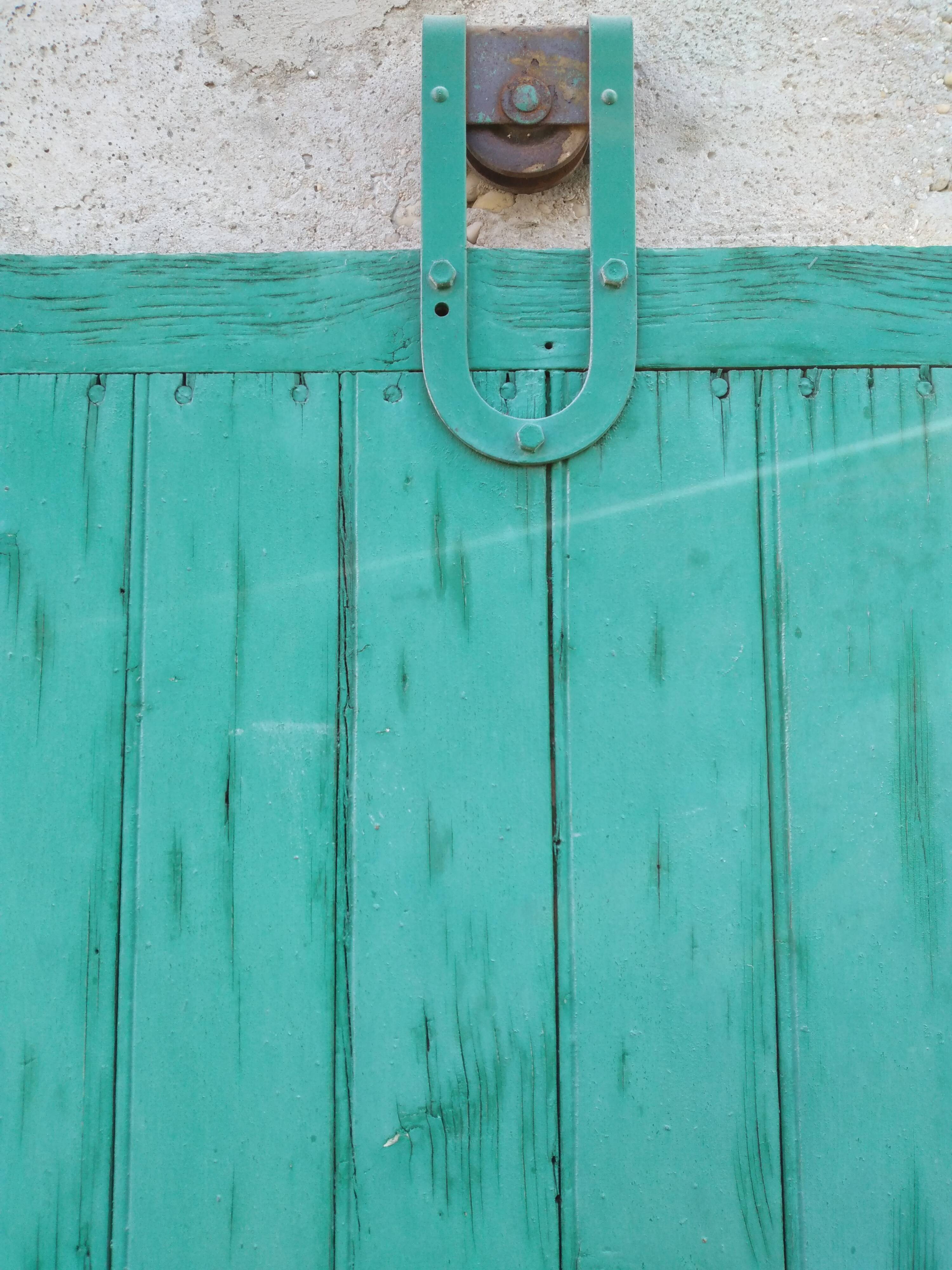 Old wooden door with pulley