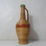 Old bottle dressed in vintage wood rattan