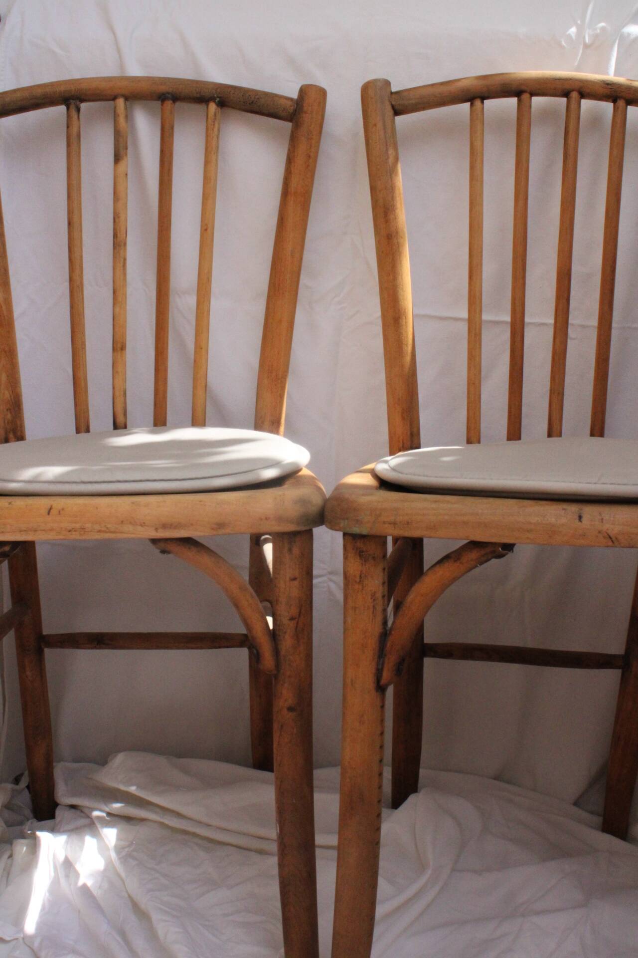 Duo of bistro chairs in bare wood, fully sanded and curved wooden backrest