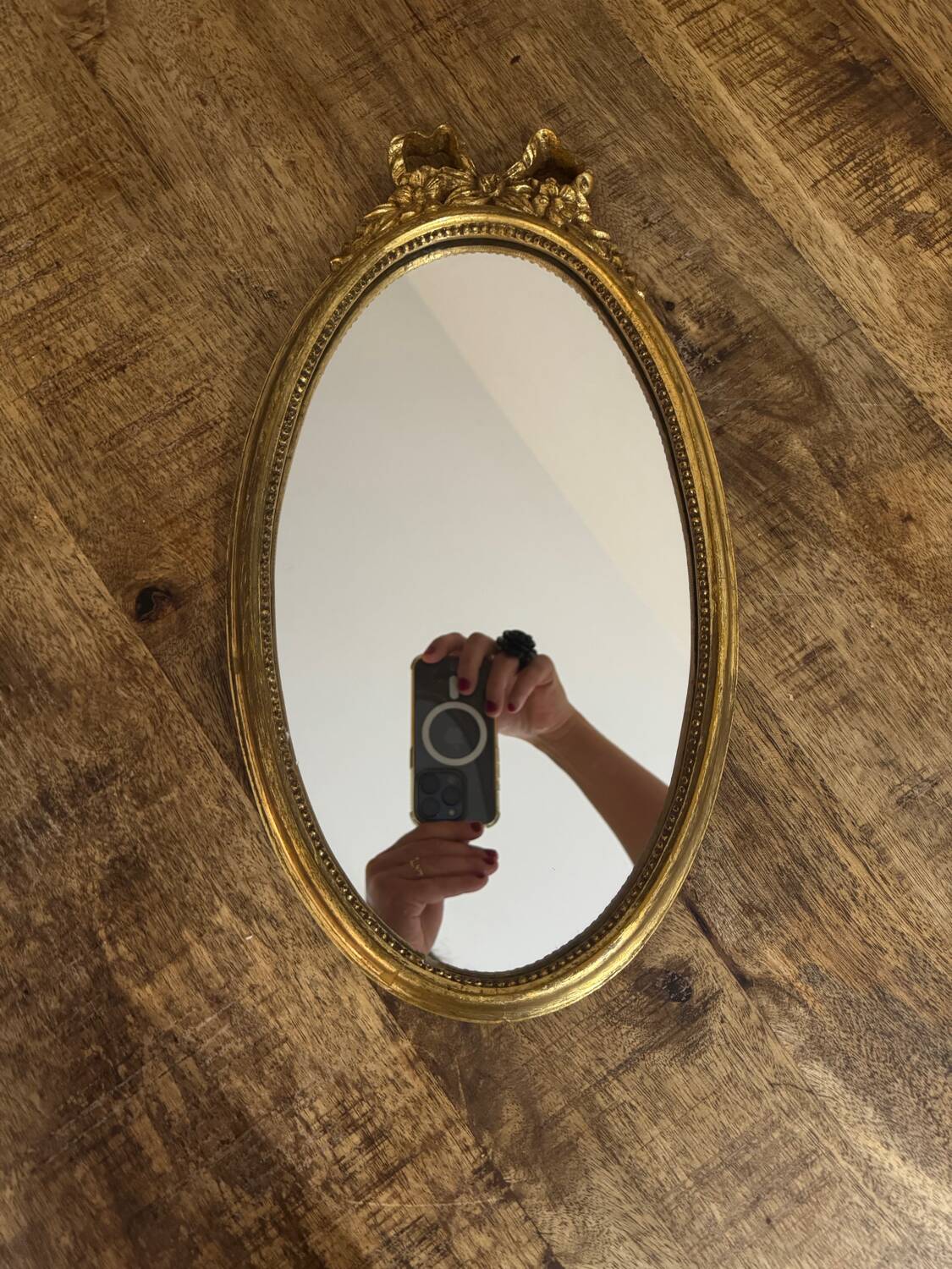 Oval gold knot mirror