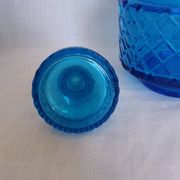 Turquoise glass carafe bottle with a stopper.