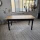 Oak farmhouse table with turned black legs.