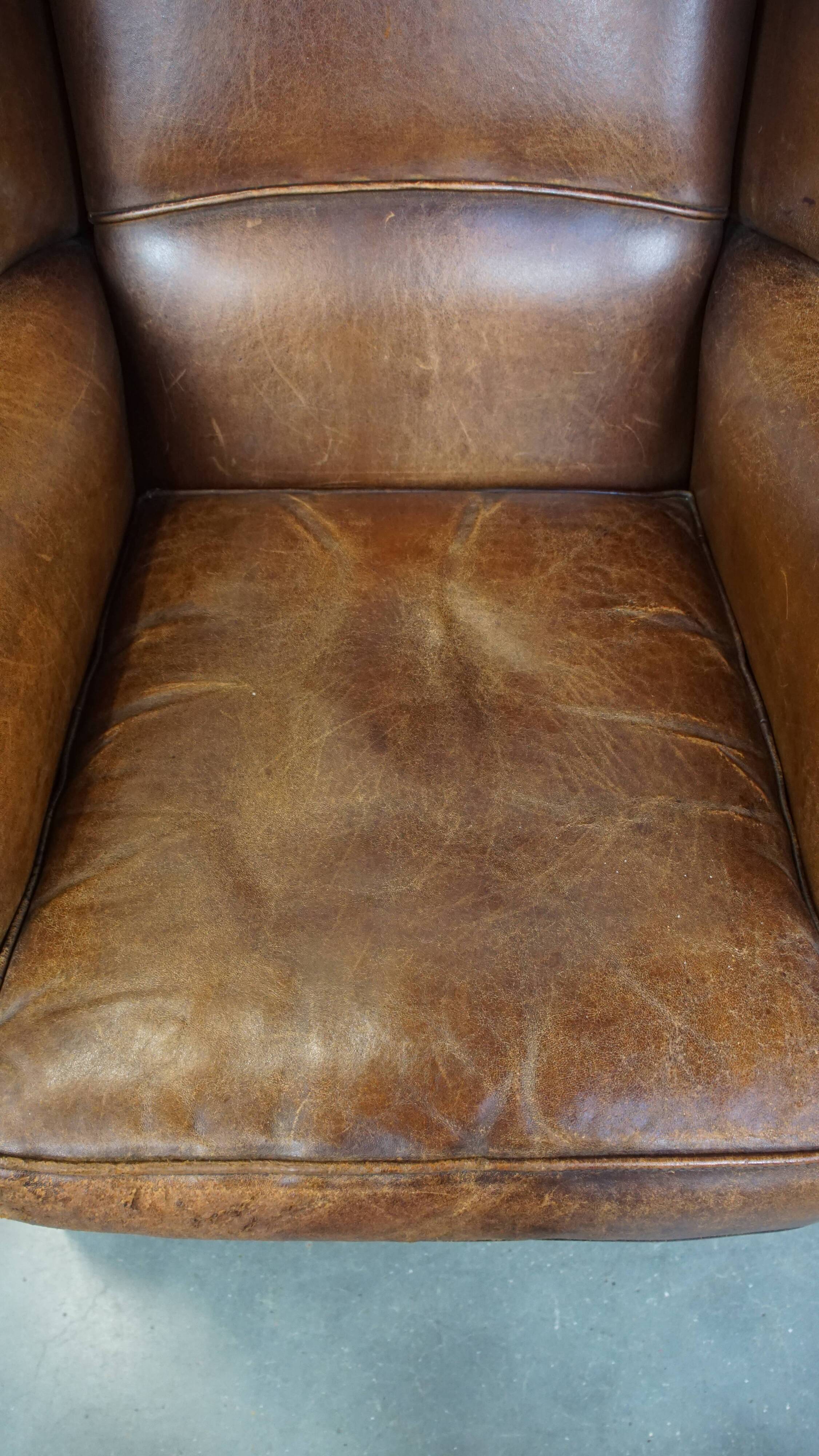Cognac-colored sheepskin wing chair in English style