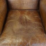 Cognac-colored sheepskin wing chair in English style