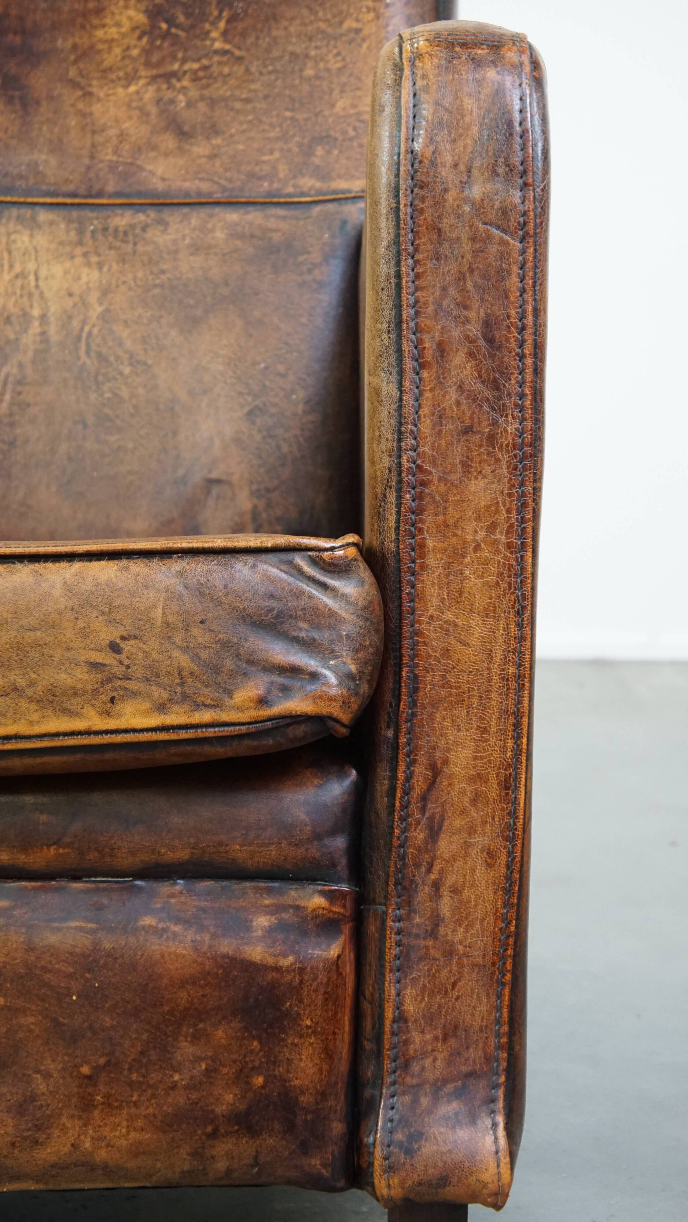 Dark brown design armchair made of sheepskin leather