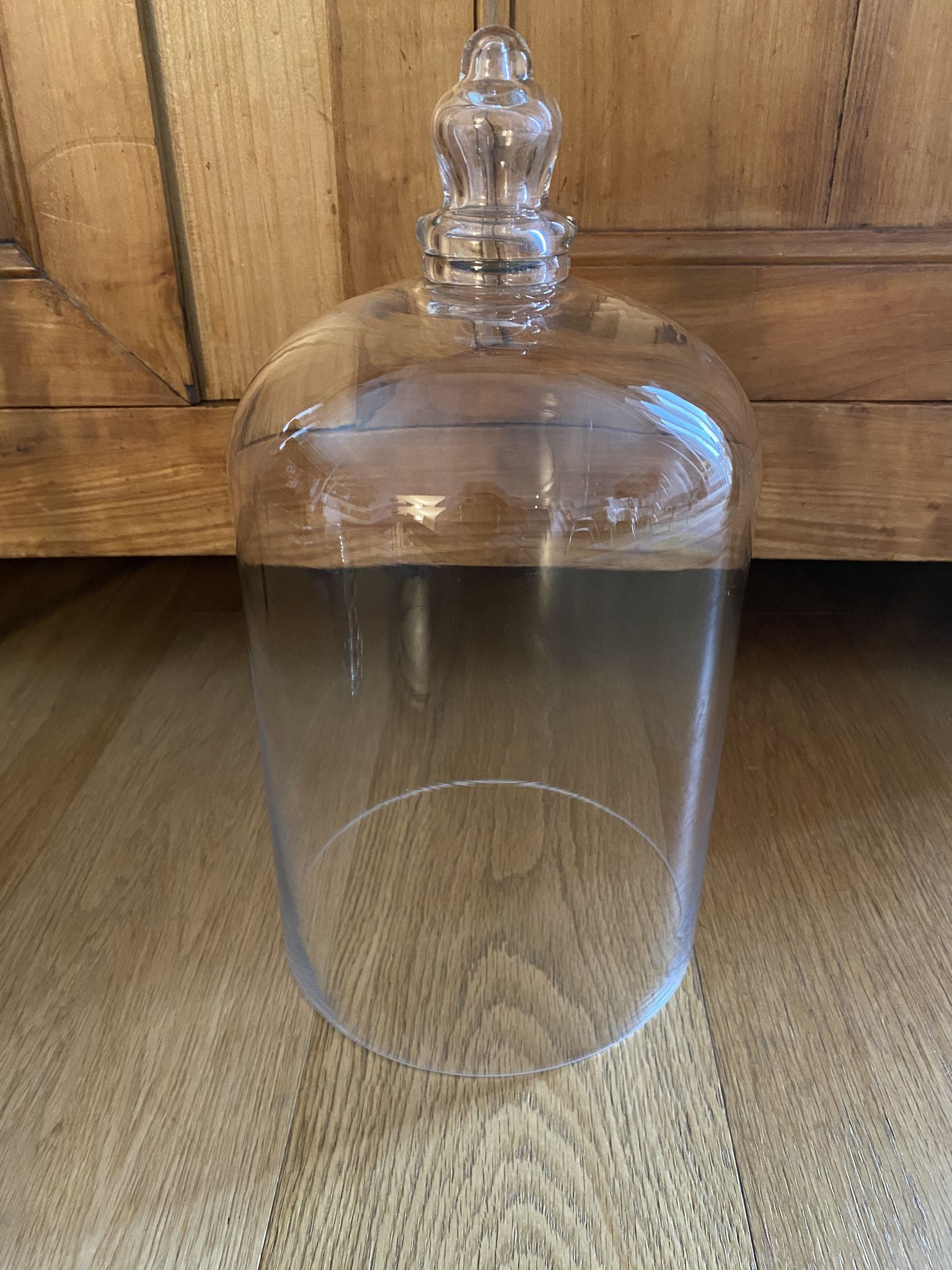 Large old glass bell and its wooden base