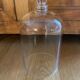 Large old glass bell and its wooden base