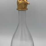 Glass bottle type carafe with gold metal bird head stopper