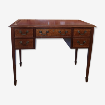 English wooden desk on top of leather