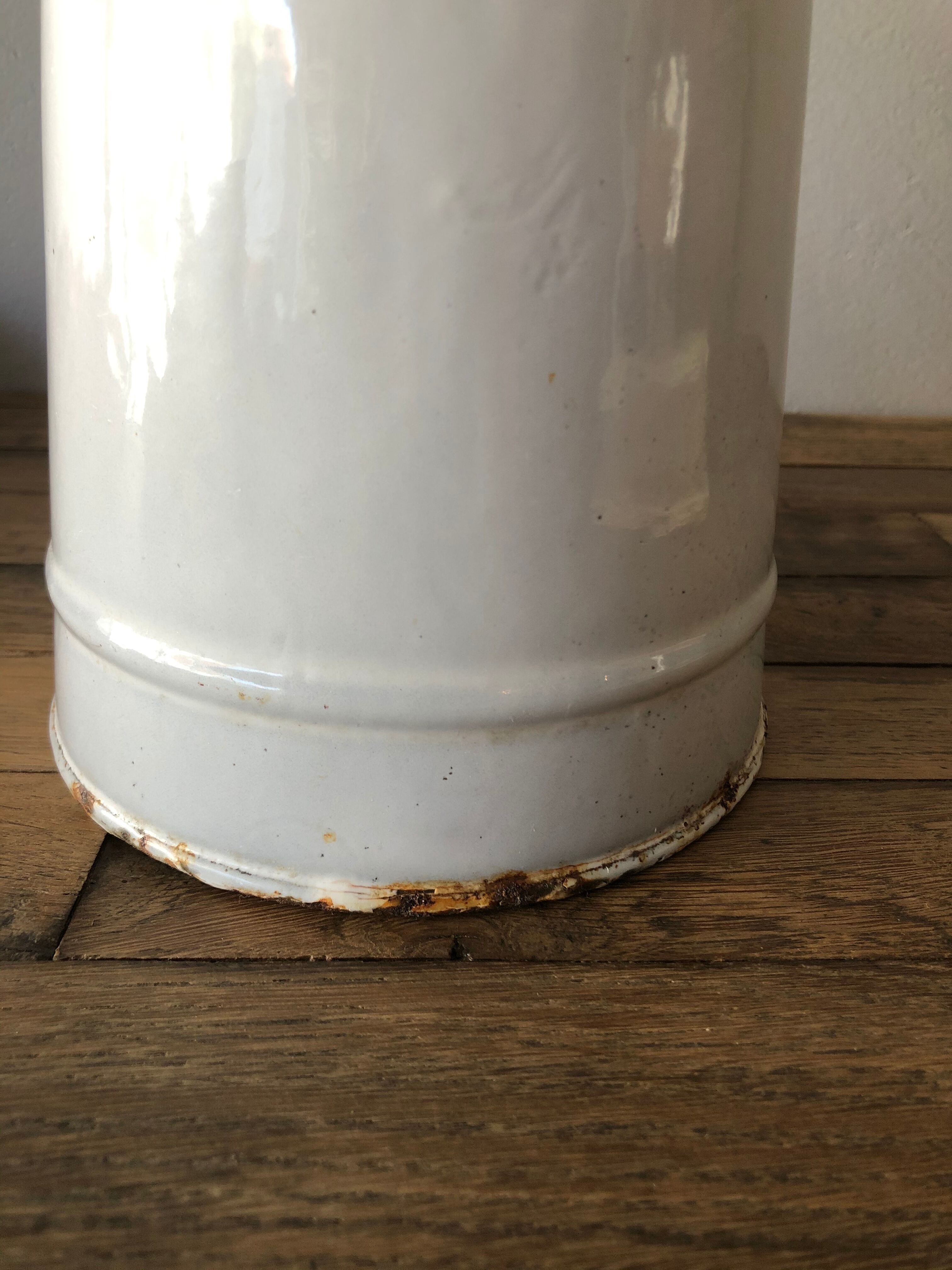 Old pitcher in enamelled sheet metal