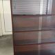 Vintage 1960s wooden library with sliding doors.