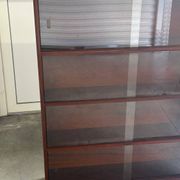 Vintage 1960s wooden library with sliding doors.