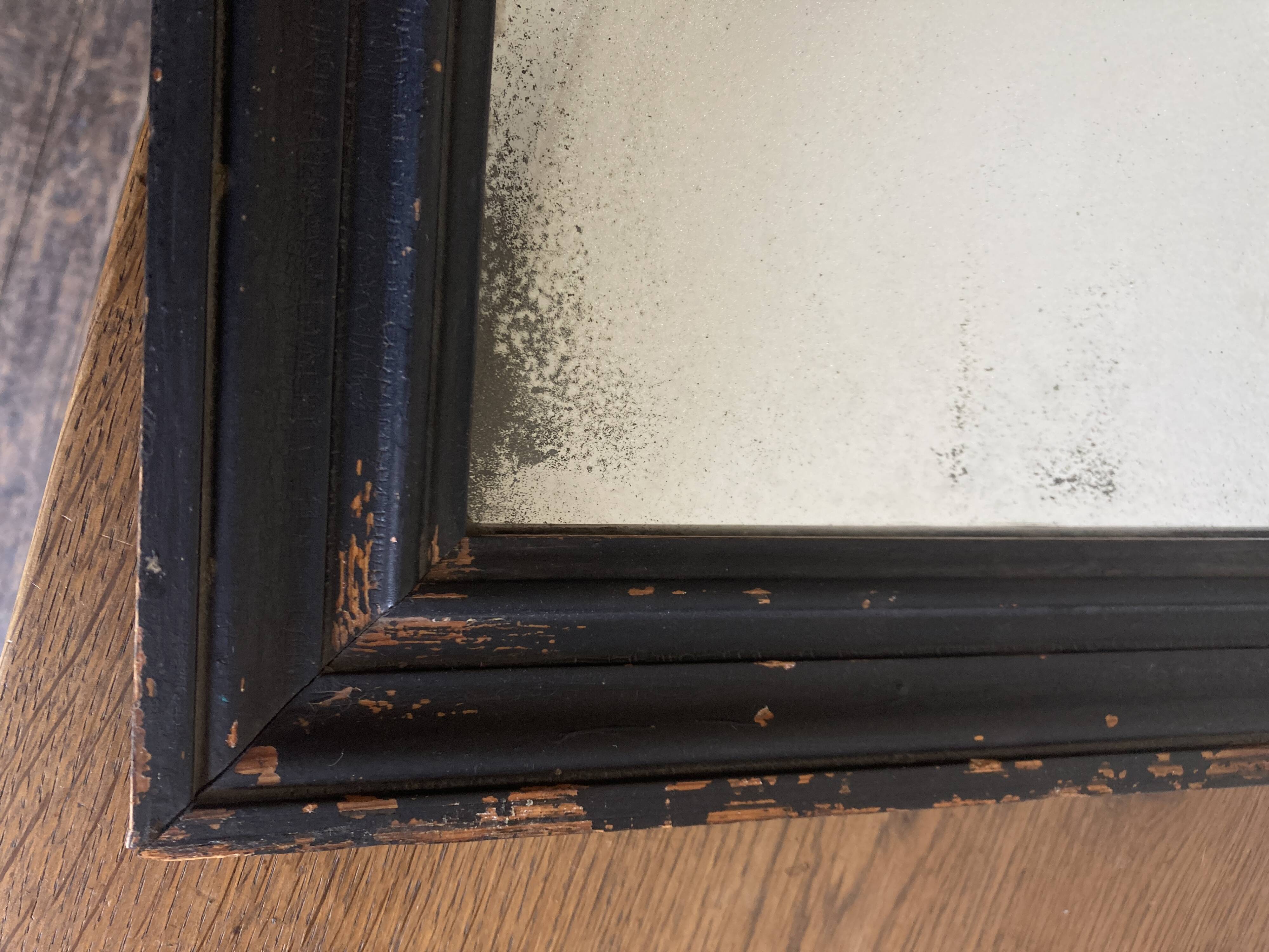 19th century blackened mirror with pitted glass 34cm x 40cm