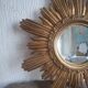 Vintage sun mirror in gilded wood. 1960