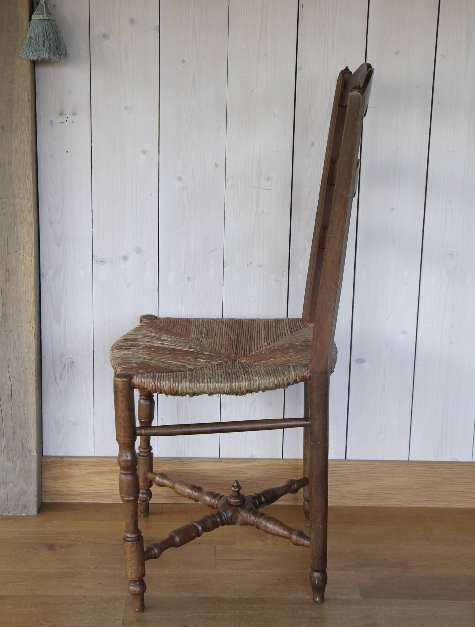 Antique chair with coloured rush seating.