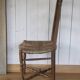 Antique chair with coloured rush seating.