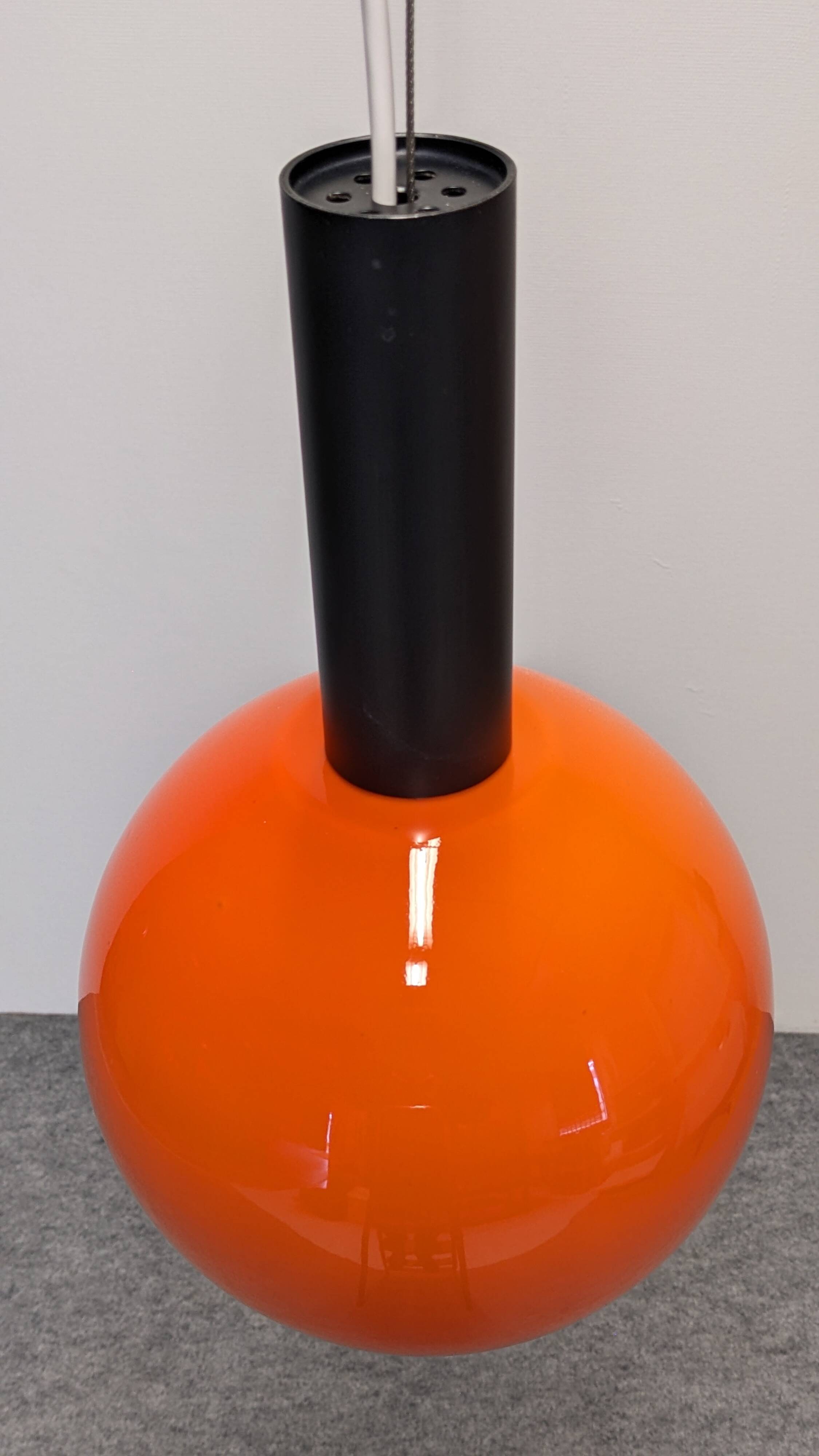 Pair of orange opaline ball pendants by Parscot, France circa 1970.