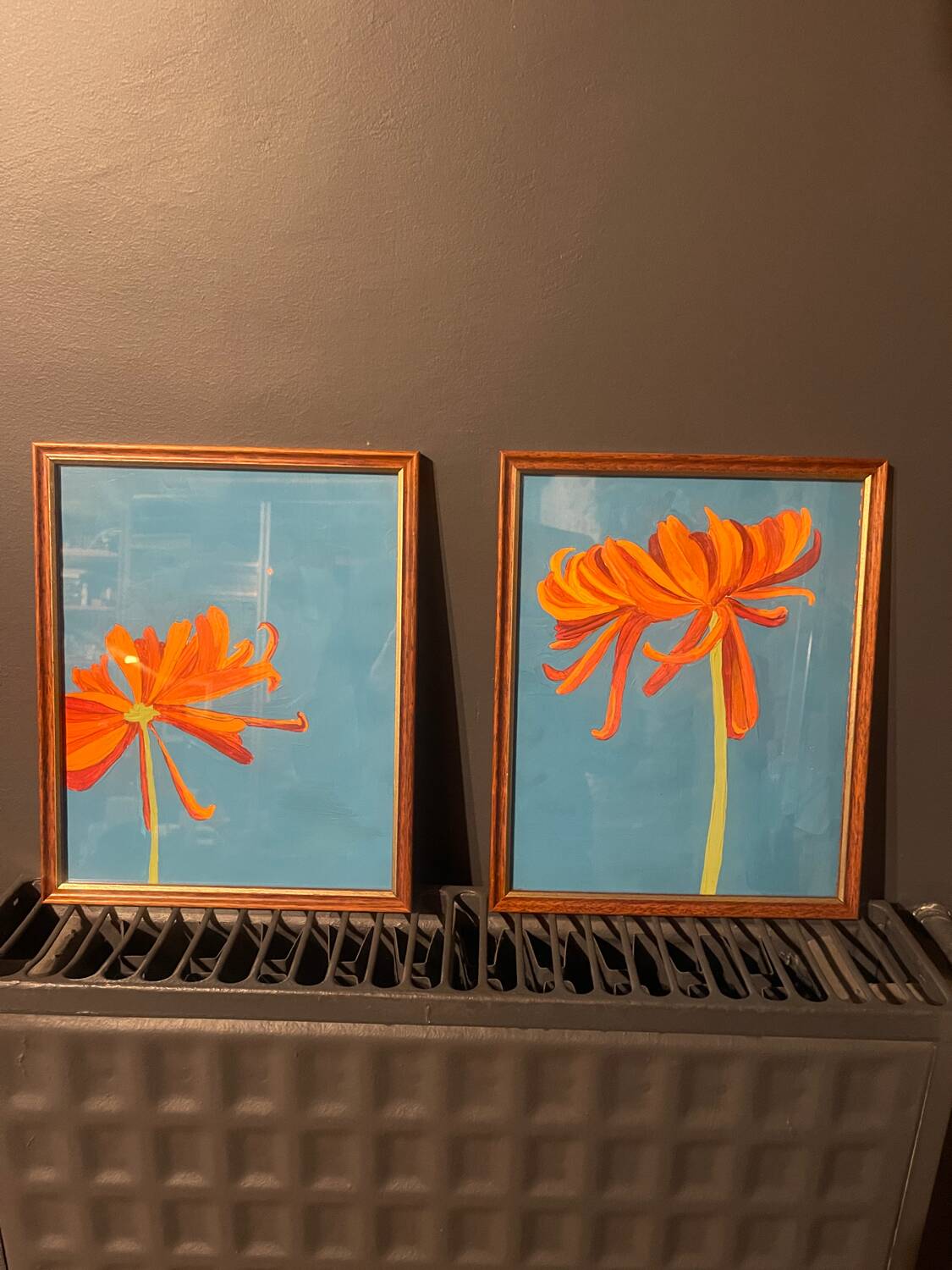2 paintings of orange dahlias in antique wooden frames