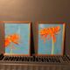 2 paintings of orange dahlias in antique wooden frames