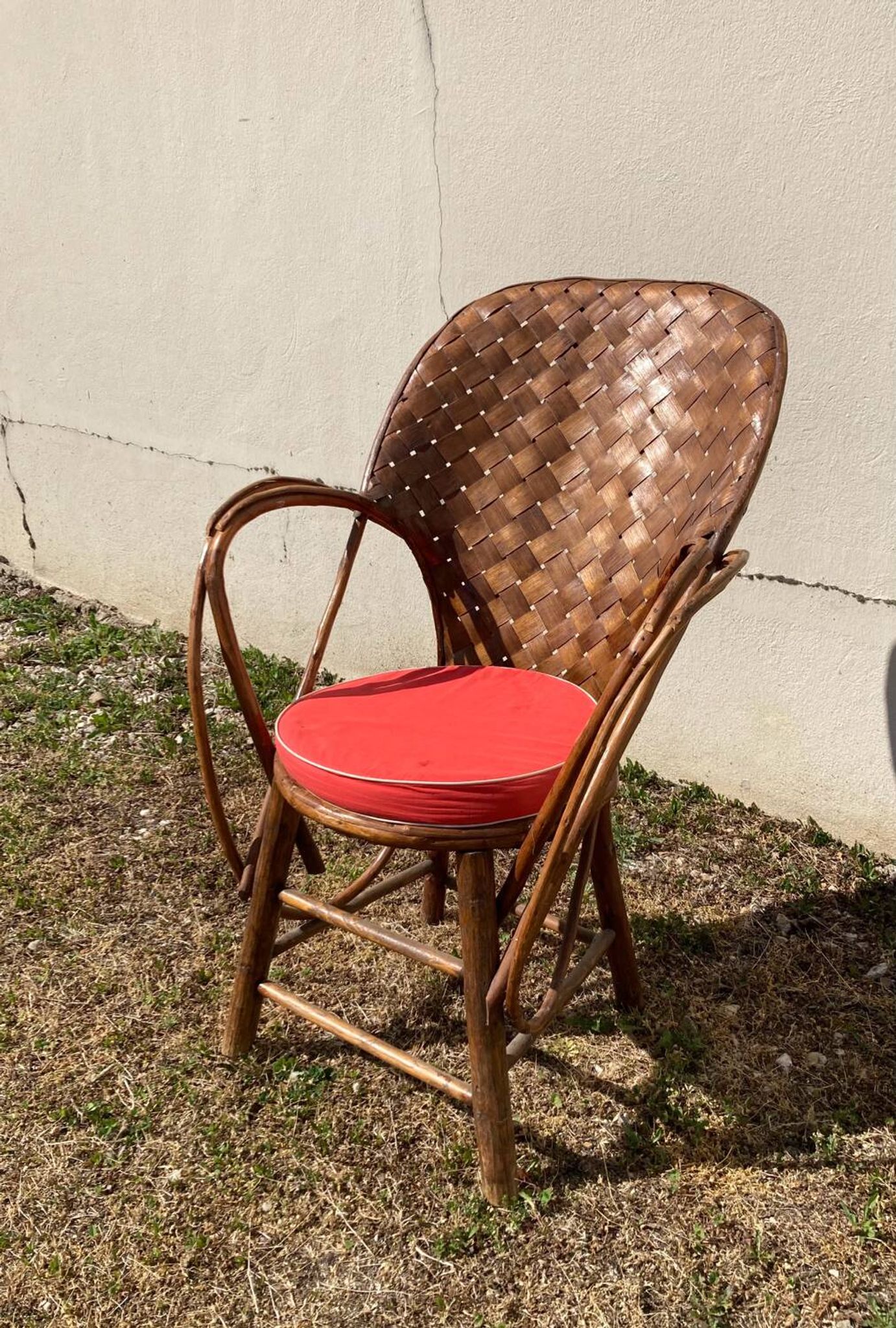 Vintage 1970s armchair in curved woven chestnut + seat cushion