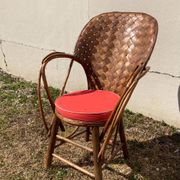 Vintage 1970s armchair in curved woven chestnut + seat cushion