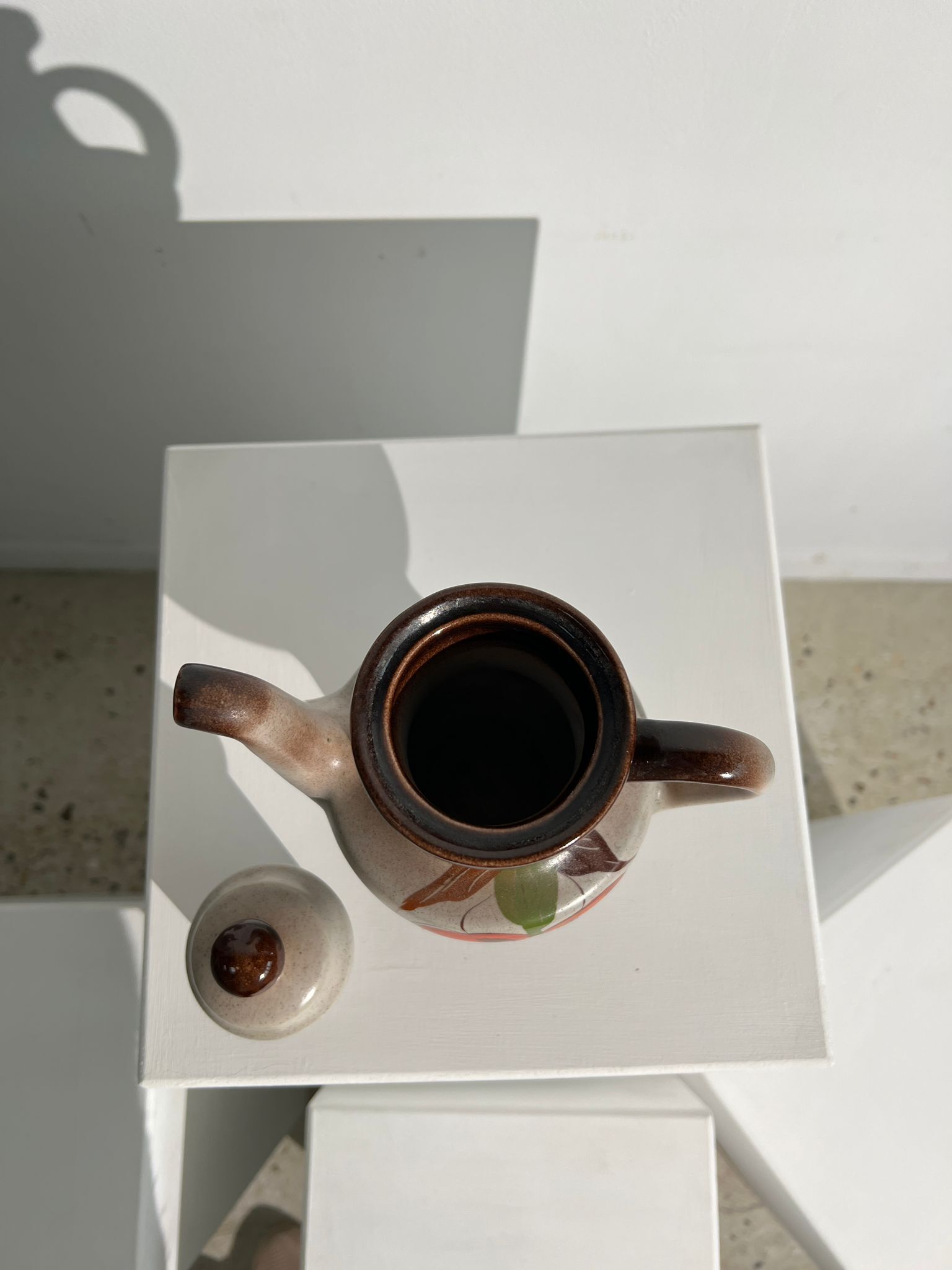 Vintage stoneware teapot with flower and fruit patterns