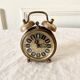 Small alarm clock old vintage watch in copper brass
