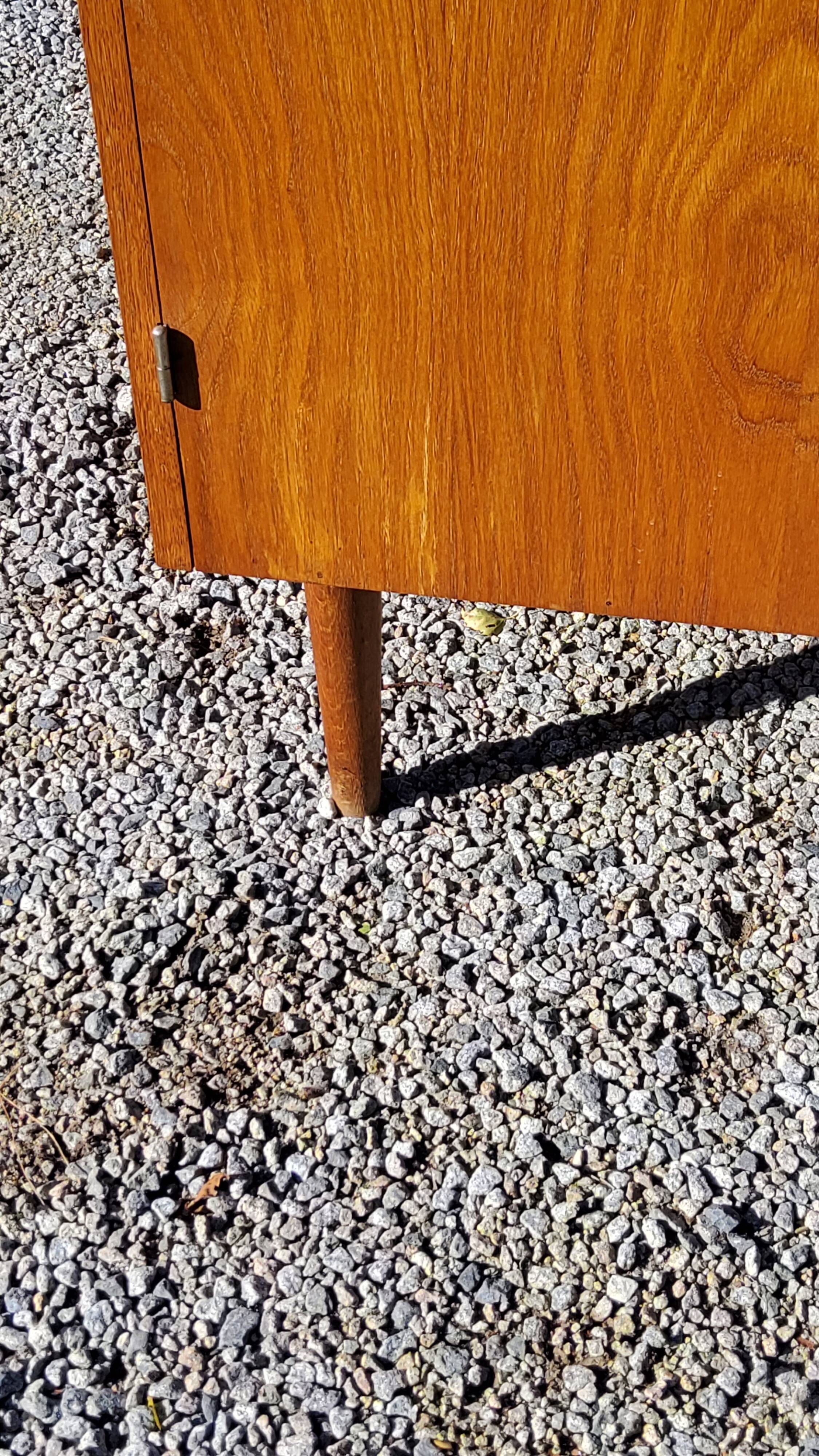 Vintage golden oak sideboard with conical legs from the 1950s