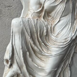 Ancient plaster bas-relief of Nike fastening her sandal.