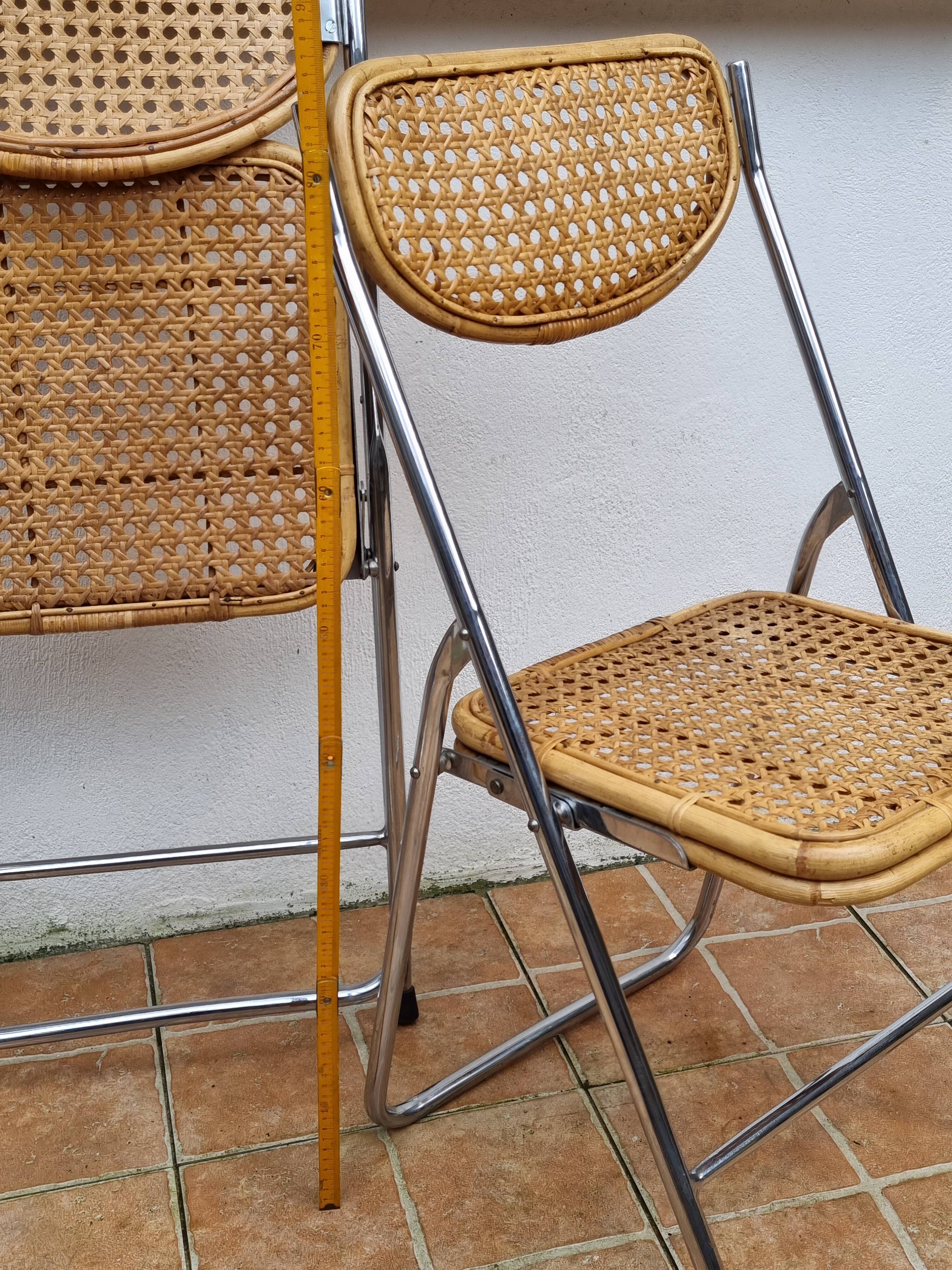 Pair of vintage metal and cane folding chairs