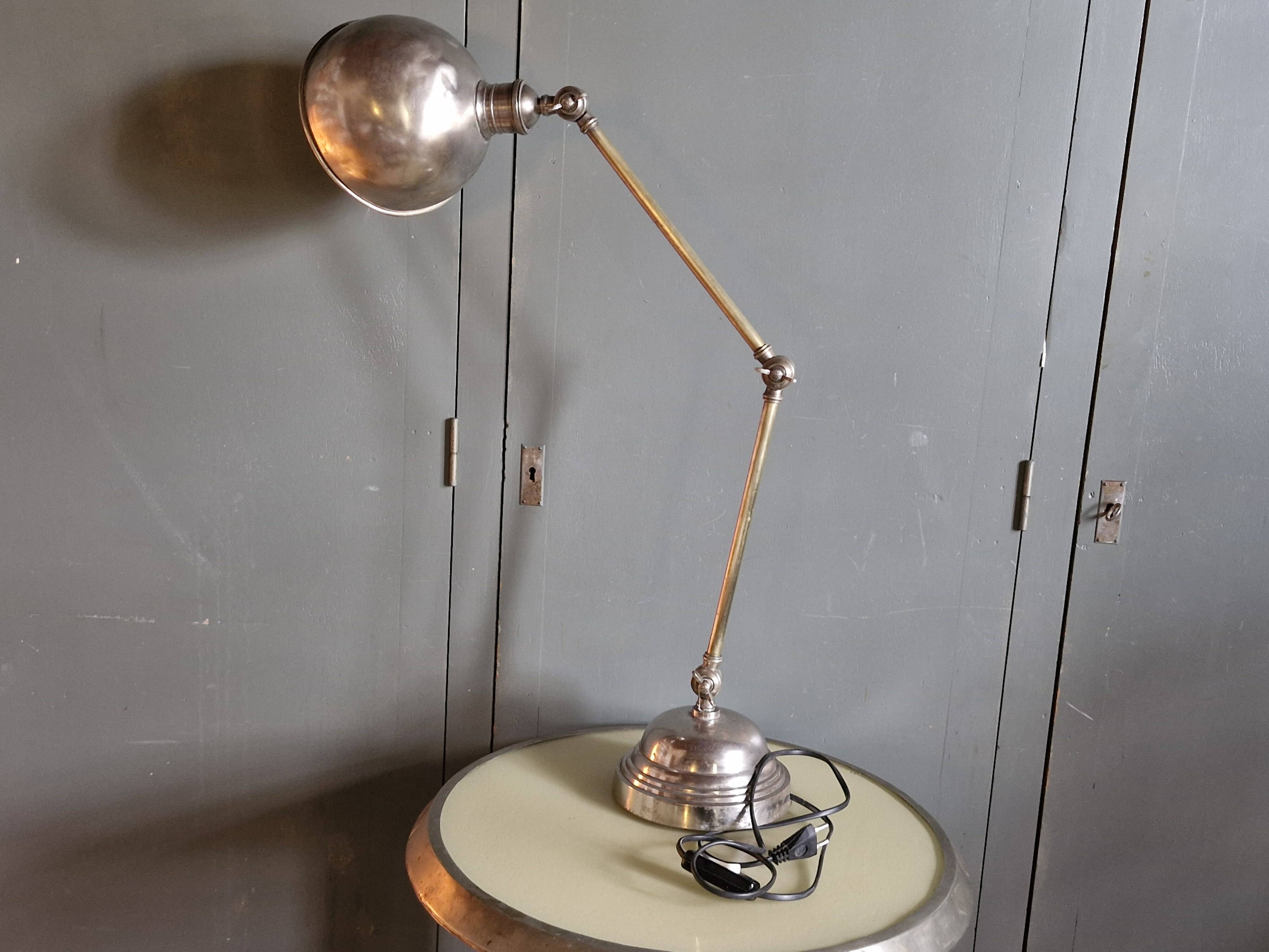 Old adjustable industrial lamp in bronze with 2 arms.